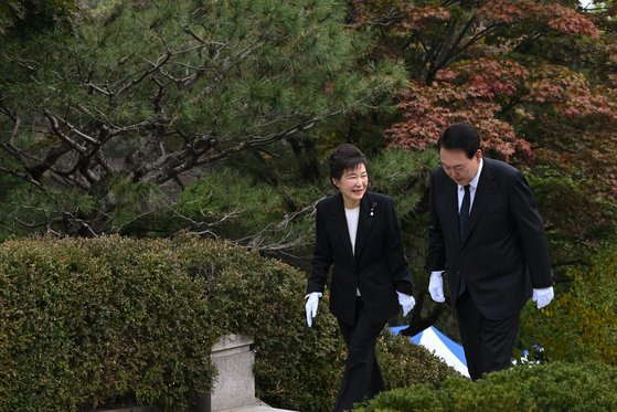 윤석열 대통령이 26일 서울 동작구 국립서울현충원에서 열린 박정희 전 대통령 서거 제44주기 추도식을 마친 후 박근혜 전 대통령과 묘소로 향하며 대화하고 있다. 사진 대통령실