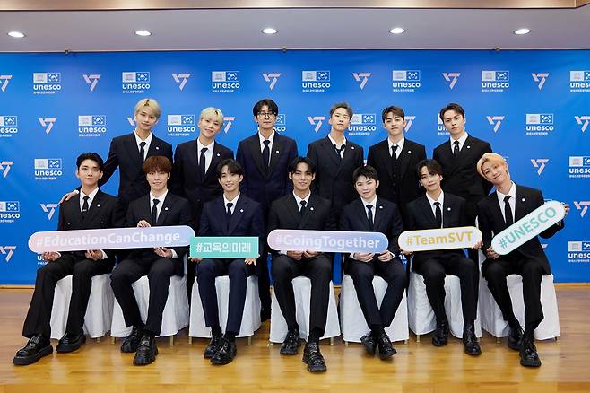 A picture provided by Pledis Entertainment shows Seventeen members posing after they sign a business partnership for the "#GoingTogether" campaign with the Korea National Council for UNESCO in August 2022. (Pledis Entertainment)