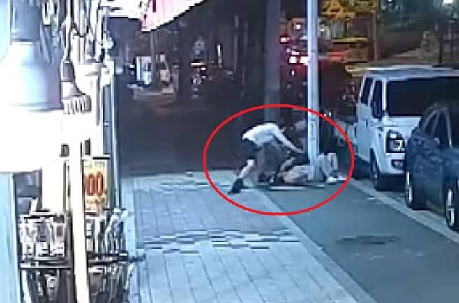 지난달 28일 전북 전주의 한 길거리에서 여학생을 무차별 폭행하고 있는 50대 남성을 제지하는&nbsp;김태진 전북대 교수(흰색 상의). 채널A 보도화면 갈무리