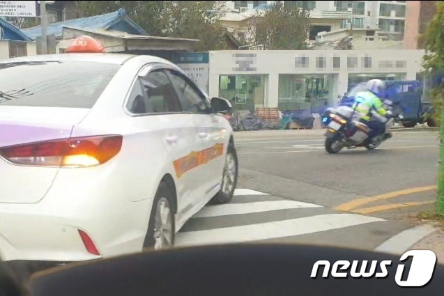 수능일인 16일 오전 부산경찰청 싸이카(오토바이)가 수험생이 타고 있는 택시를 에스코트하고 있다.(부산경찰청 제공)