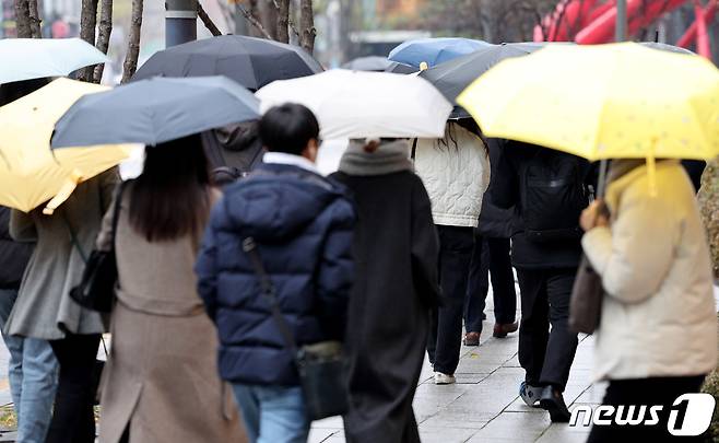 서울에 비가 내린 27일 오전 서울 종로구 종각역 인근에서 우산을 쓴 시민들이 출근길에 나서고 있다. 기상청은 오늘 전국 곳곳에 눈과 비가 내린 뒤 내일부터 다시 영하권 날씨가 찾아온다고 예보했다. 2023.11.27/뉴스1 ⓒ News1 장수영 기자