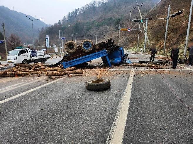 지난 6일 강원 춘천시 신동면 혈동리에서 트럭이 산 아래로 굴러떨어져 트럭에 실려 있던 목재가 승용차를 덮치는 사고가 났다. ‘보배드림’ 캡처
