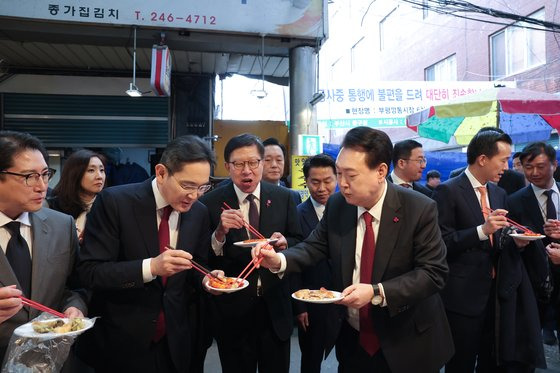 윤석열 대통령이 지난 6일 부산 중구 깡통시장을 방문해 박형준 부산시장, 이재용 삼성전자 회장 등 기업인들과 함께 분식을 시식하고 있다. 사진 대통령실=뉴스1