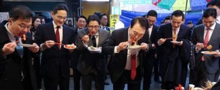 윤석열 대통령이 지난 6일 부산 중구 깡통시장에서 이재용 삼성전자 회장 등 기업 총수들과 떡볶이 등 분식을 시식하고 있다. 연합뉴스