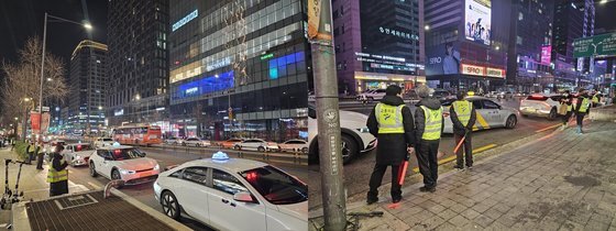 지난 8일 자정쯤 서울 홍대입구역 9번 출구 인근에 설치된 임시 택시 승차대 주변에 '심야승차지원단'이 시민의 택시 승차를 안내하고 있다. 나운채 기자