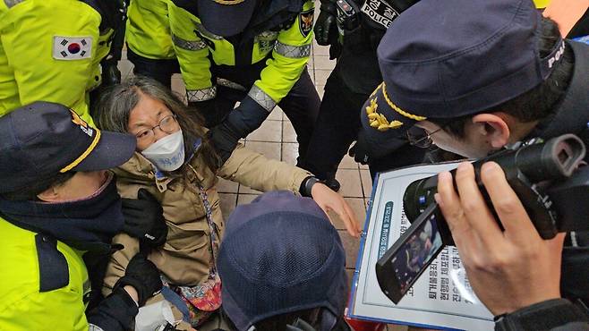 15일 서울지하철 4호선 혜화역 역사 안에서 침묵시위를 하던 전장연 활동가가 경찰에 연행되고 있다. 김채운 기자