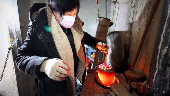 18일 경기 과천시 비닐하우스촌 '꿀벌마을'에서 윤모(66)씨가 2구짜리 연탄 보일러에 연탄을 갈고 있다. 꿀벌마을은 서울의 달동네 개발 등으로 밀려난 주민들이 수십년 전부터 모여 살기 시작한 비닐하우스촌이다. 김현동 기자