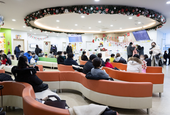 Patients and their caretakers wait for their turn in the waiting room to see a doctor at a hospital in Seoul on Tuesday. [NEWS1]
