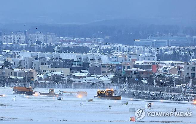 폭설 내린 제주공항 제설작업 '한창' (제주=연합뉴스) 박지호 기자 = 북극발 한파가 몰아친 21일 오후 제주국제공항 활주로에서 한국공항공사 제설차량이 눈을 치우고 있다. 2023.12.21 jihopark@yna.co.kr