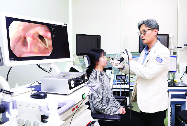 가톨릭의대 이비인후과 조정해 교수가 왼쪽 성대마비로 시술받은 환자의 상태를 후두 내시경으로 확인하고 있다. 성빈센트병원 제공