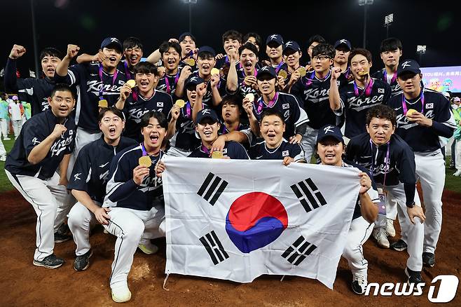 대한민국 야구 대표팀이 7일 중국 사오싱 야구·소프트볼 스포츠센터 제1구장에서 열린 2022 항저우 아시안게임 야구 결승전에서 대만을 2-0으로 꺾고 금메달을 획득한 후 마운드에 태극기를 펼치고 기념 촬영을 하고 있다. 대한민국은 아시안게임 4연패 금자탑을 기록했다. 2023.10.7/뉴스1 ⓒ News1 유승관 기자