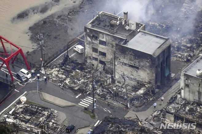 [와지마=AP/뉴시스] 3일 일본 이시카와현 와지마의 지진으로 타버린 건물에서 연기가 피어오르고 있다. 지난 1일 이시카와현 노토반도에서 발생한 지진으로 지금까지 사망자 숫자는 최소 62명으로 늘어났다. 2024.01.03.