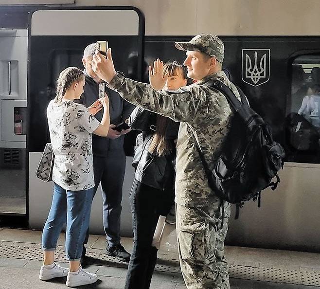걱정마, 다시 돌아올거야 - 지난 18일(현지 시각) 우크라이나 수도 키이우의 중앙역에서 전선으로 떠나는 군인을 가족들이 배웅하고 있다. /정철환 특파원