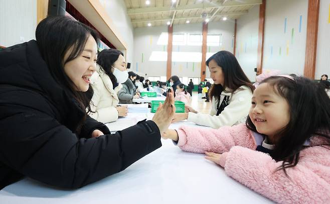 지난해12월26일 오후 경기도 수원시 영통구 영덕초등학교에서 열린 신입생 예비 소집에서 예비 초등학생이 선생님과 인사하고 있다.(사진=연합뉴스)