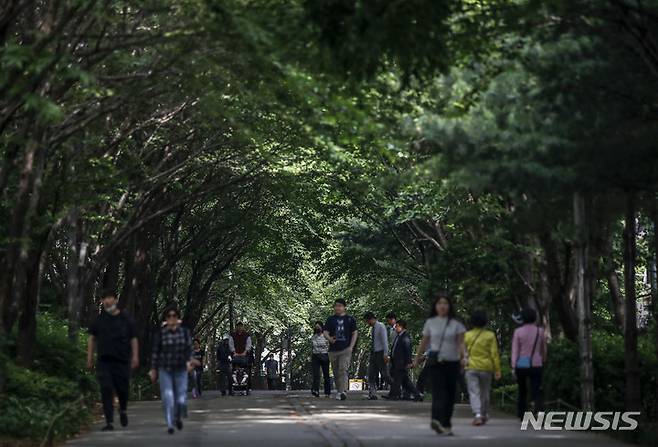 [서울=뉴시스] 정병혁 기자 = 서울 낮 최고 기온이 27도까지 오르면서 초여름 날씨를 보일 것으로 예보된 24일 서울 마포구 경의선숲길에 조성된 나무그늘 아래에서 시민들이 이동하고 있다. 2023.05.24. jhope@newsis.com