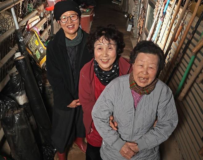 충남 천안시 광덕면 용경마을에서 농사와 시를 짓는 김해자 시인(왼쪽)이 지난 11일 이웃 ‘할매 언니’인 맹대열(오른쪽)·양승분씨와 함께 승분씨 집의 오래된 농기구들 앞에서 웃고 있다. 이정용 선임기자 lee312@hani.co.kr