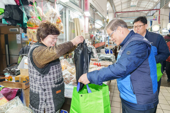 김한성 월성본부장이 시장상인과 덕담을 나누며 장을 보고 있다.