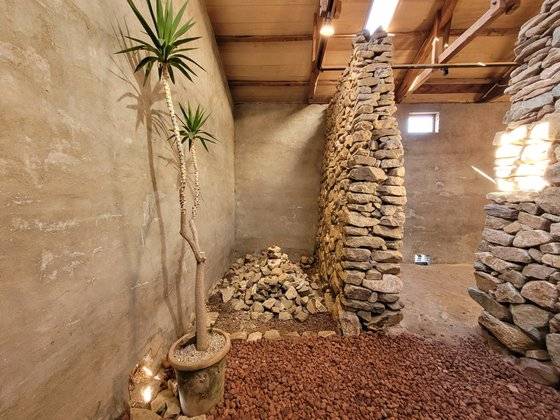 지난해 11월 경남 남해군 삼동면 시문마을 돌창고 전시장 내부 모습. 앞서 남해 돌 문화를 다룬 '돌돌돌' 전시 때 설치한 가나스톤 석공 김수남 작가의 작품 ‘다랑논’이 남아 있다. 안대훈 기자