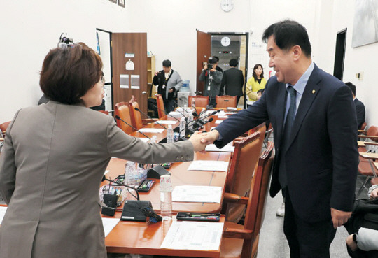 실거주 의무를 3년간 유예하는 주택법 개정안 등을 심사하기 위해 21일 국회에서 열린 국토교통위원회 국토법안심사소위원회에서 김정재(왼쪽) 소위원장이 맹성규 더불어민주당 의원과 악수하고 있다. 연합뉴스