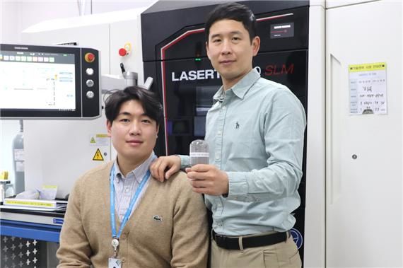[대전=뉴시스] 생기원 박형기 수석연구원(오른쪽)과 임현태 연구원이 개발한 3D프린팅 티타늄 분말소재를 들어보이고 있다.(사진=생기원 제공)  *재판매 및 DB 금지