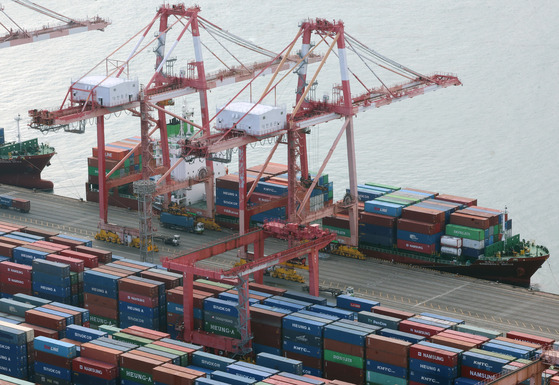 Containers for exports and imports are piled at a pier in the southeastern port city of Busan on Jan. 1, 2024. [Yonhap]