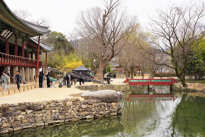Staff of Tving's upcoming period drama "Chunhwa Love Story" prepare to shoot a scene in front of Gwanghallu Pavilion on Monday. (Lee Si-jin/The Korea Herald)