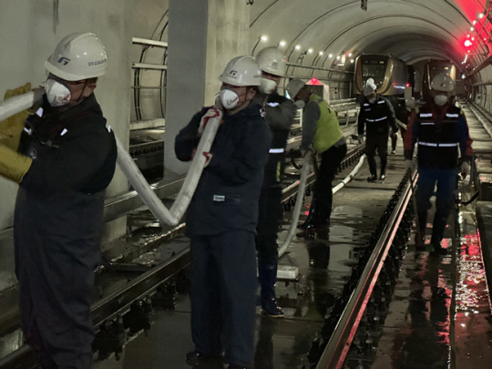 김포공항역 터널 내 노반 물청소를 하고 있는 김포골드라인 직원들. 김포골드라인 제공