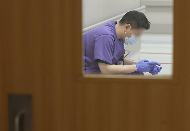 잠깐의 휴식 전공의 공백을 메우고 있는 한 의료인이 27일 서울시내 대형병원에서 휴식을 취하고 있다. 연합뉴스