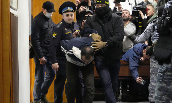 지난 24일(현지시각) 러시아 모스크바 공연장 테러 용의자 사이다크라미 라차발리조다(30)가 경찰에 이끌려 모스크바 지방법원에 출석하고 있다. 모스크바=AP뉴시스