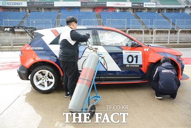 아이오닉 5 N eN1 컵카의 에어 잭 리프트를 활용해 차량을 정비하는 모습. 질소를 주입구로 넣으면, 차 하부에 설치된 리프트 막대가 나와 차량을 스스로 들어 올린다. /김태환 기자