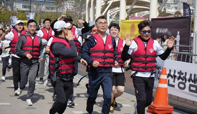 김영철 창원해경서장(앞줄 가운데) 등 창원해경 직원들이 구명조끼를 입은 채 마라톤 코스를 달리고 있다. [사진제공=창원해양경찰서]