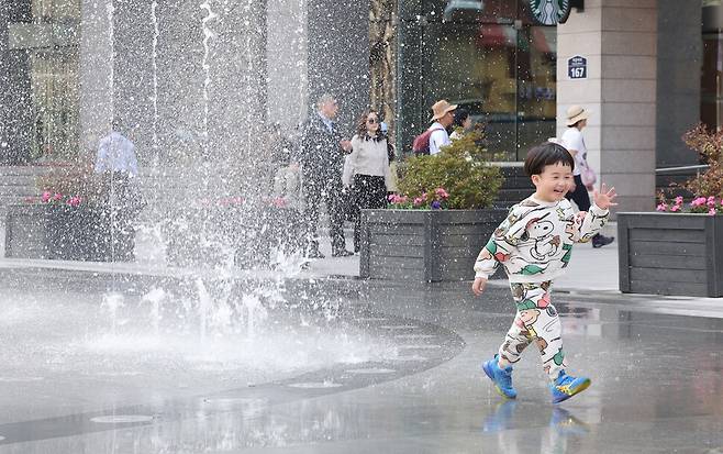 서울 낮 최고 기온이 24도까지 올라간 2일 오후 김우주(4)군이 서울 종로구 광화문광장에서 가벼운 옷차림으로 물놀이를 하고 있다. 김영원 기자 forever@hani.co.kr