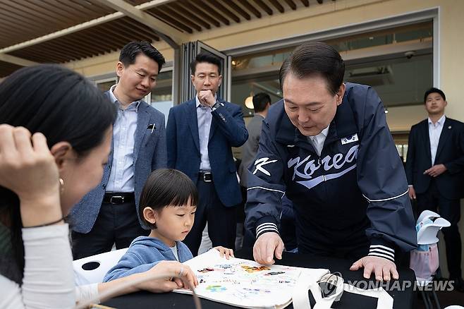 윤석열 대통령, 용산어린이정원 프로그램 참관 (서울=연합뉴스) 홍해인 기자 = 윤석열 대통령이 6일 서울 용산어린이정원 내 분수 정원의 잼잼카페에서 열린 에코백 만들기 프로그램을 참관하며 어린이와 대화하고 있다. 2024.4.6 [대통령실 제공. 재판매 및 DB 금지] hihong@yna.co.kr