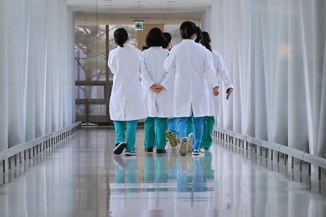 전국 의대 교수들의 '무더기 사직'이 본격적으로 시작되며 의정갈등이 장기화하는 가운데 26일 서울 시내 한 대학병원에서 의료진이 이동하고 있다 ⓒ연합뉴스