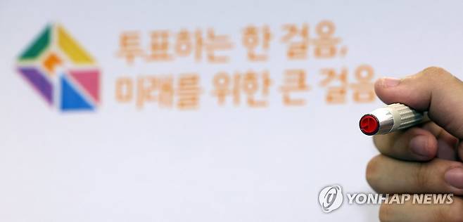 총선 D-1 (서울=연합뉴스) 박동주 기자 = 제22대 국회의원선거를 하루 앞둔 9일 오후 서울 영등포구 YDP미래평생학습관에 마련된 투표소에서 관계자가 기표용구를 들어보이고 있다. 2024.4.9 pdj6635@yna.co.kr