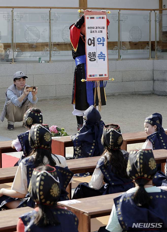 [서울=뉴시스] 최동준 기자 = 13일 서울 강남구 못골한옥어린이도서관에서 유생복장을 한 어린이들이 과거시험 방식으로 독서경연을 하고 있다. 2024.04.13. photocdj@newsis.com