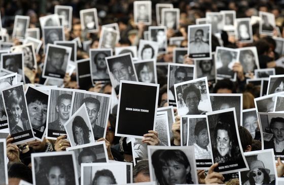 2012년 7월 18일 아르헨티나 수도 부에노스아이레스에서 85명의 사망자와 300여명의 부상자를 낸 아르헨티나-이스라엘 친섭협회(AMIA) 건물 폭탄 테러 18주기를 추모하기 위해 모인 사람들이 피해자들의 초상화를 들고 있다. AFP=연합뉴스