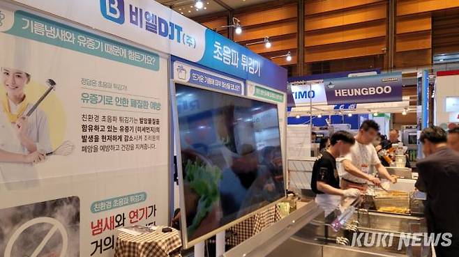 초음파 튀김기를 구경하는 방문객들. 사진=김건주 기자