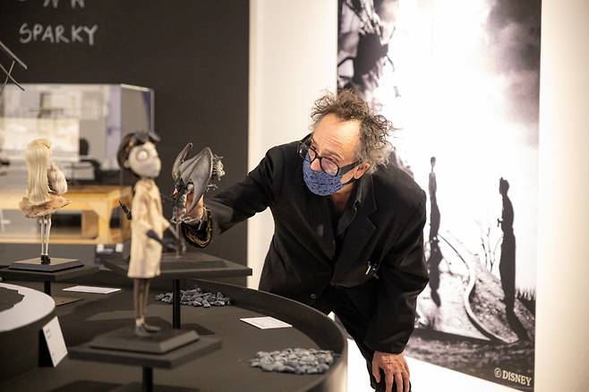 American director Tim Burton observes his sculptures that resemble the characters from his 2012 film, “Frankenweenie,” ahead of his exhibition “The World of Tim Burton,” at the Dongdaemun Design Plaza in April 2022. (GNC Media)
