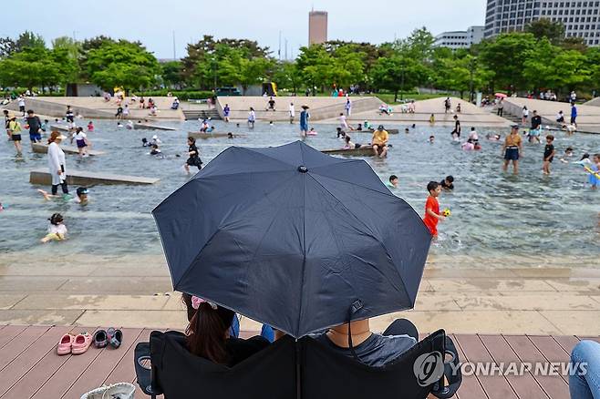 초여름 더위사냥 방법은 제각각 (서울=연합뉴스) 서대연 기자 = 서울 한낮 기온이 28도까지 오르며 초여름 날씨를 보인 28일 오후 서울 영등포구 여의도한강공원 물빛광장에서 양산을 쓴 시민들이 물놀이하는 시민들을 바라보고 있다. 2024.4.28 dwise@yna.co.kr