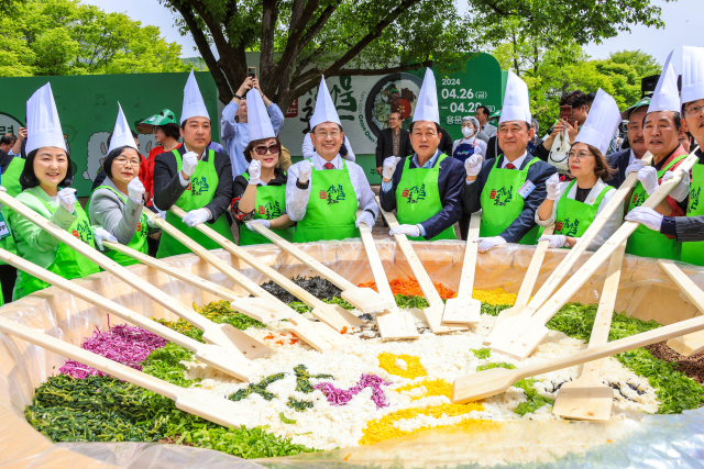▲제14회 양평 용문산 산나물 축제에 참석한 지역 인사들이 '비빔밥퍼포먼스'에 참여하고 있다. ⓒ양평군