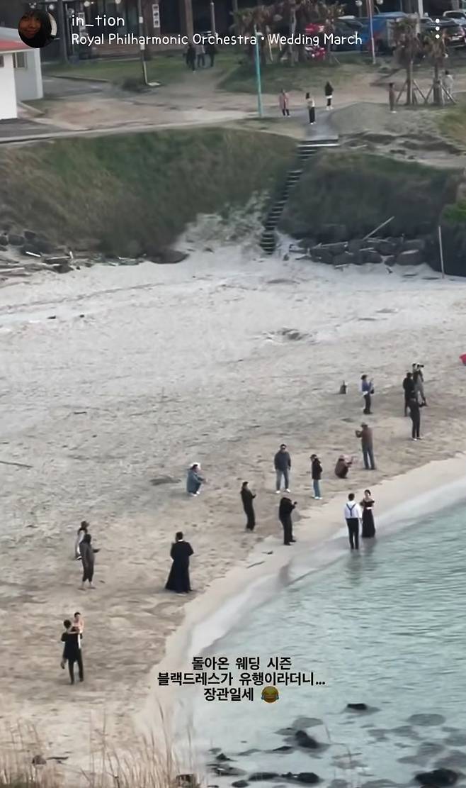 지난 4월 제주 함덕서우봉해변에서 웨딩 스냅 사진을 찍는 수십 명의 신랑 신부가 '블랙' 드레스와 턱시도를 입어 화제가 된 영상. /in_tion 인스타그램