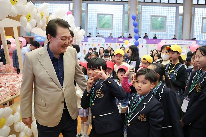 윤석열 대통령이 지난해 5월 5일 제101회 어린이날을 맞은 5일 청와대 연무관에서 열린 전국 어린이가족 320여명 초청행사에 참석해 어린이에게 팝콘을 나눠주고 있다./대통령실 제공