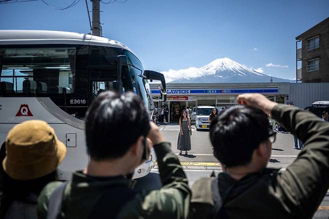 3일 일본 야마나시현에서 중국 관광객들이 후지산을 배경으로 사진을 찍고 있다. [AFP]