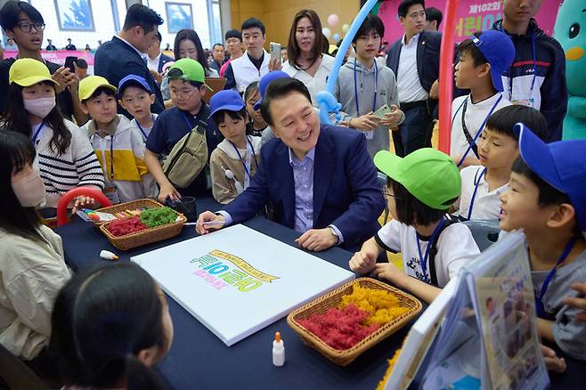 [서울=뉴시스]윤석열 대통령이 5일 청와대 연무관에서 열린 제102회 어린이날 초청행사에서 공기정화식물 액자 만들기 체험 부스를 찾아 어린이들과 대화를 나누고 있다. (사진=대통령실 제공)  2024.05.05. photo@newsis.com *재판매 및 DB 금지