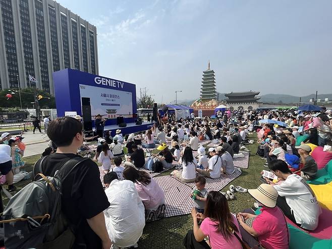 서울 시민들이 광화문광장 육조마당에 개최된 지니 TV 팝업에서 '서울시 퍼포먼스'를 즐기는 모습
