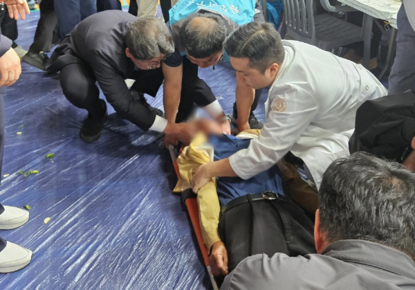홍태용 김해시장이 지난 10일 오전 행사장에 쓰러진 어르신의 건강상태를 살피며 응급 진료를 하고 있다. 김해시 제공