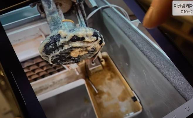 A component of an ice maker before being cleaned (Screenshot from a video on the I am a Businessperson YouTube channel)