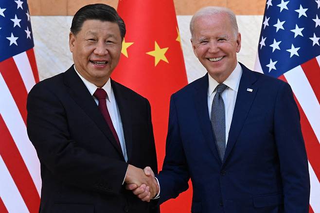 US President Joe Biden (R) and China‘s President Xi Jinping (L) shake hands as they meet on the sidelines of the G20 Summit in Nusa Dua on the Indonesian resort island of Bali on November 14, 2022. (Photo by SAUL LOEB / AFP)