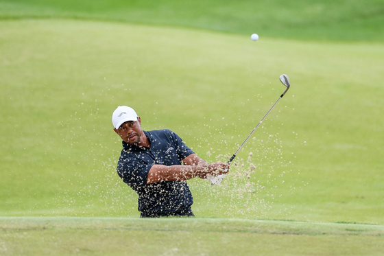 Tiger Woods of the United States plays his shot from the bunker on the seventh hole during a practice round prior to the 2024 PGA Championship at Valhalla Golf Club in Louisville, Kentucky on Tuesday. [AFP/YONHAP]